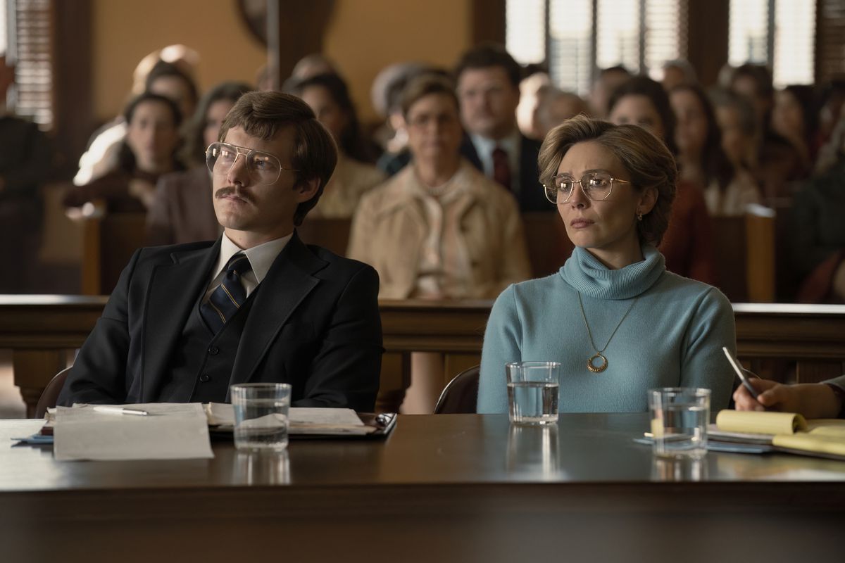 Candy (Elizabeth Olsen) sits next to her lawyer in court in a still from Love & Death