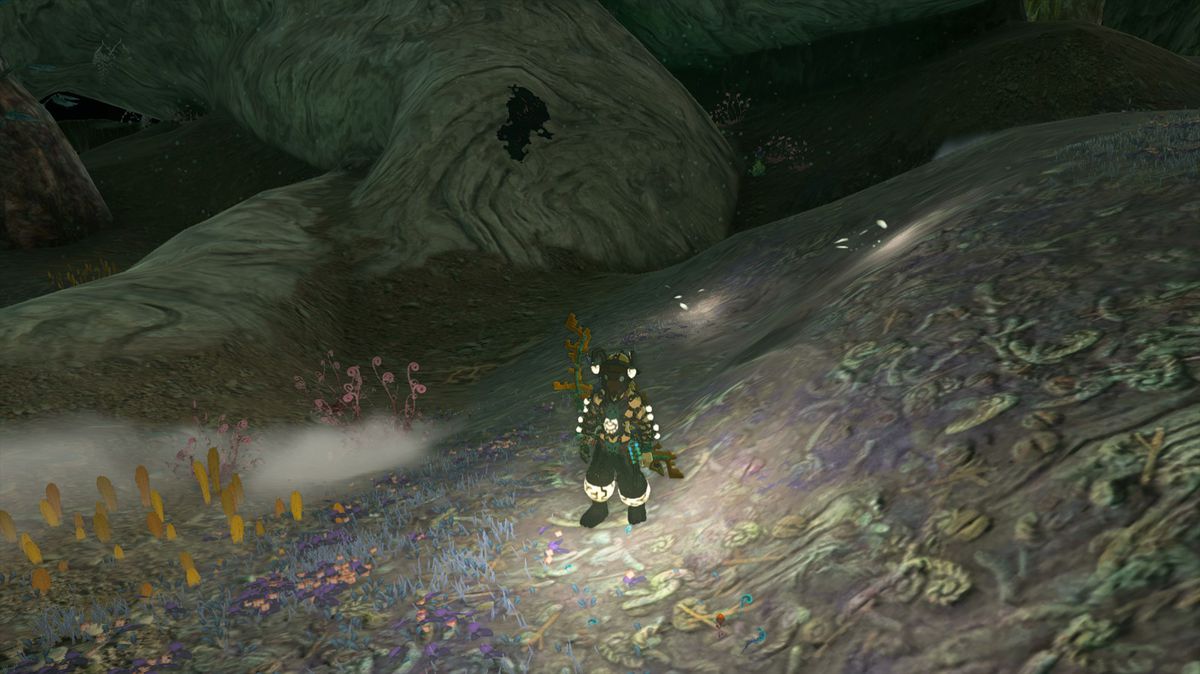 Link in the Tears of the Kingdoms Depths in the Miner's Armor med flera små ljuspölar runt sig.