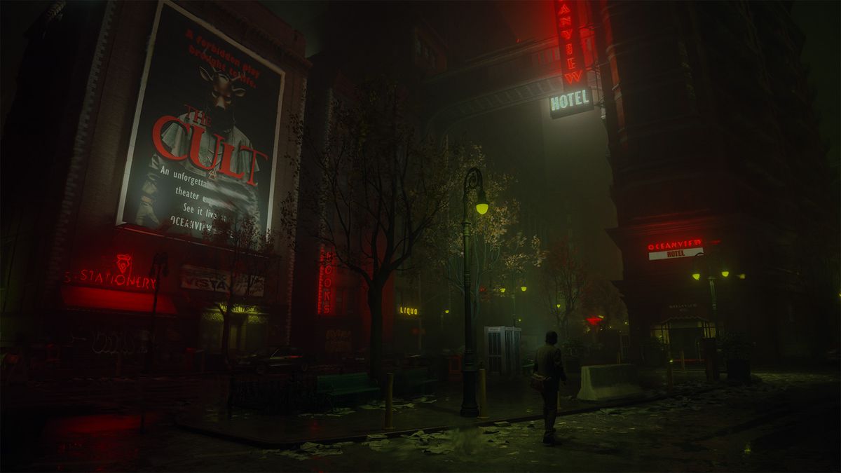 Alan Wake går genom en mörk stad omgiven av skyltar på en skräckfilm med titeln 