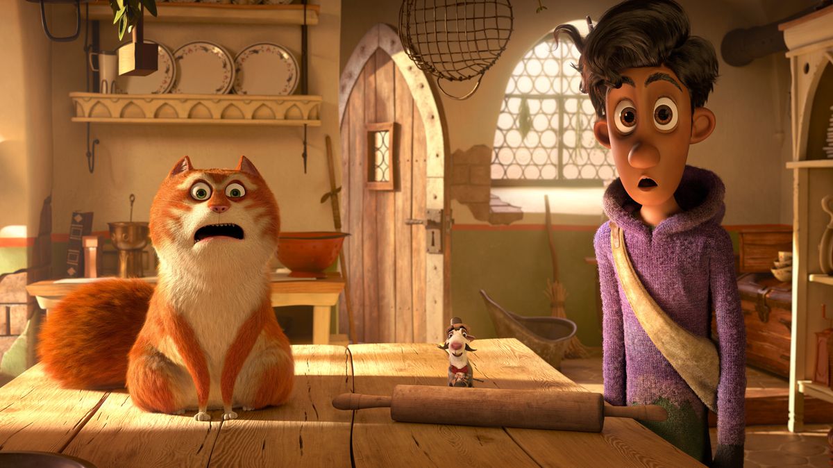 (L-R) An orange and white cat (Hugh Laurie) and a young man in a purple hoodie (Himesh Patel) stare with their mouths agape in a kitchen in The Amazing Maurice.