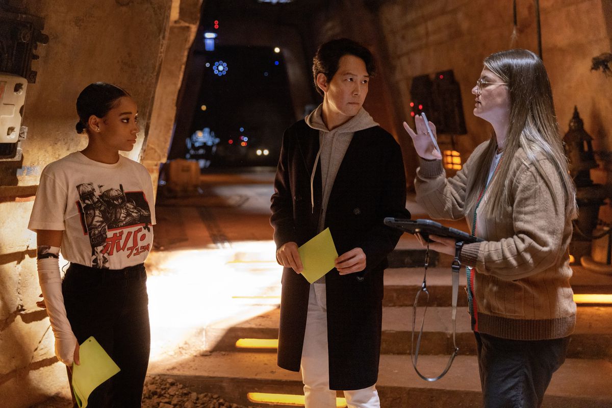 Leslye Headland, Amandla Stenberg, and Lee Jung-jae stand on the set of Star Wars: The Acolyte