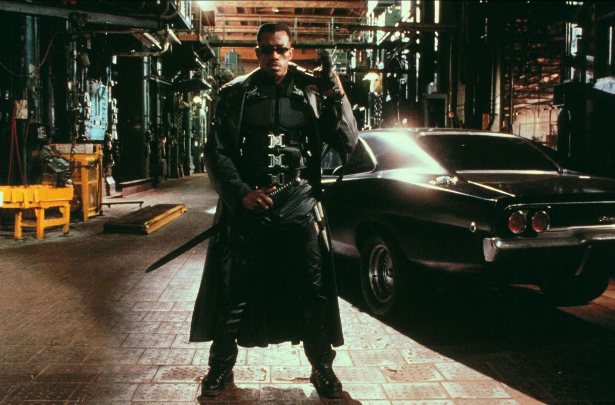 Wesley Snipes stands in a street with sword in hand from the movie Blade