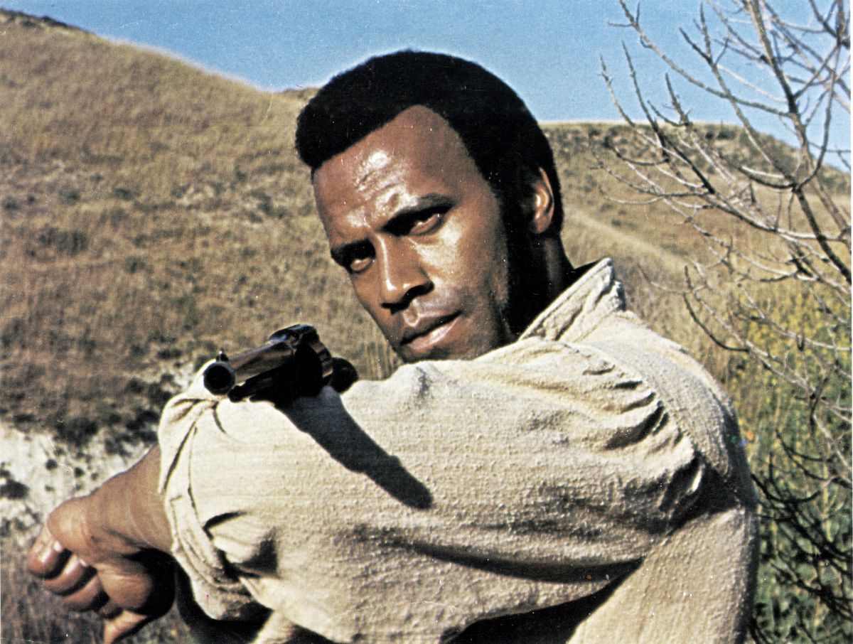 Fred Williamson points a revolver over his sleeve in The Legend of N***** Charley