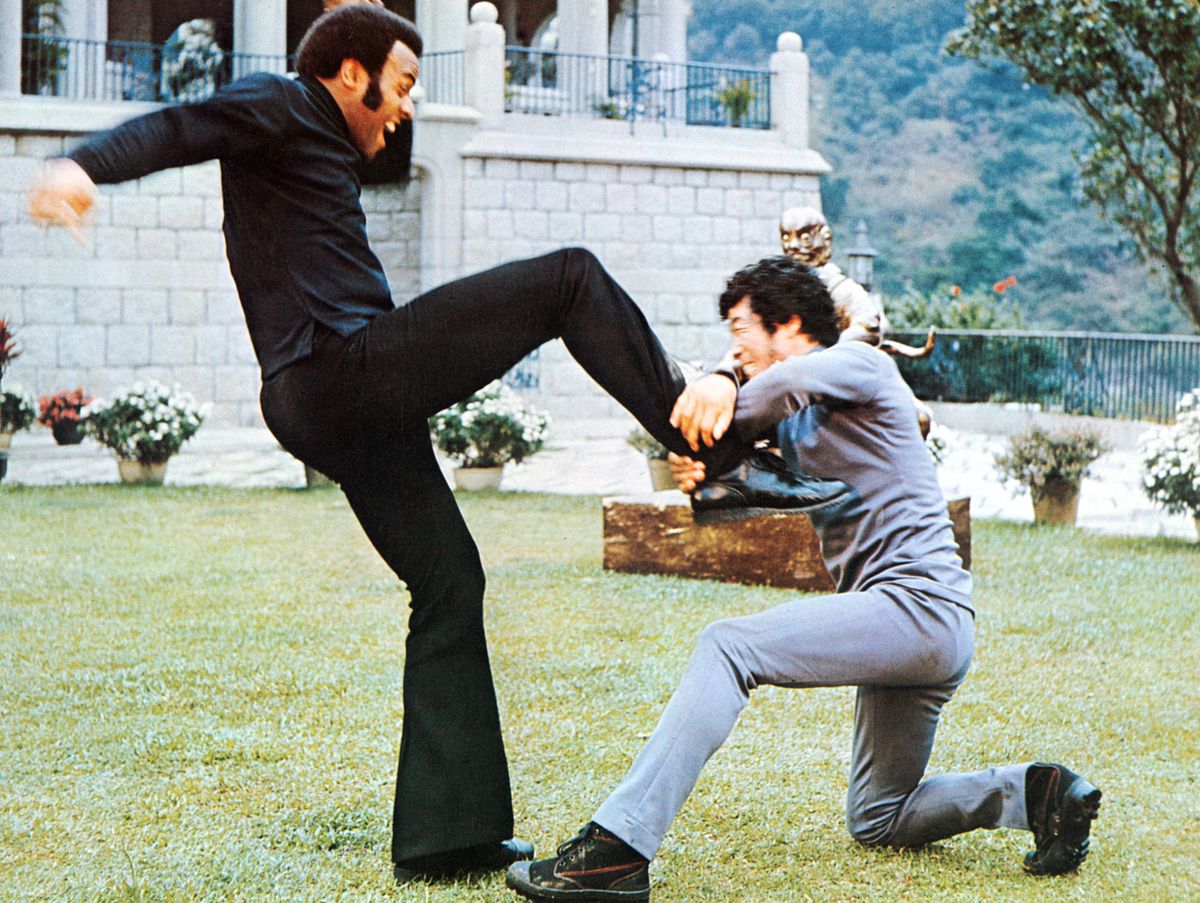 Fred Williamson kicks Masatoshi Nakamura in the chest outdoors in That Man Bolt.