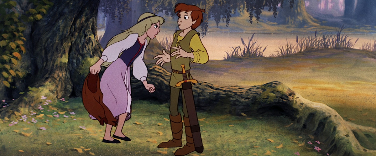 Princess Eilonwy, a young blonde girl in a flowing dress, stands in a forest in the shade of a huge tree and shouts at Taran, a young commoner boy in green, carrying a huge sword, in Disney’s The Black Cauldron