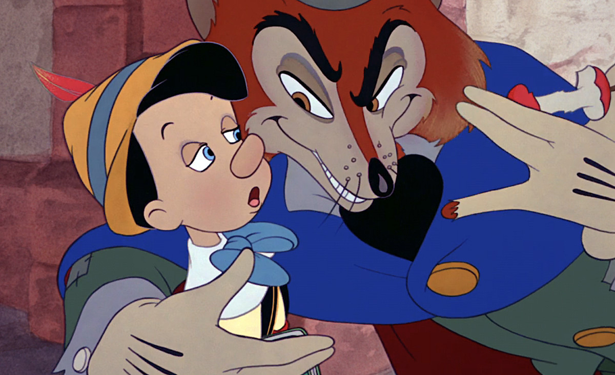 Pinocchio, a young wooden boy with an extremely derpy look on his face, listens to bad advice from the maliciously smiling, gentlemanly Fox in Disney’s Pinocchio