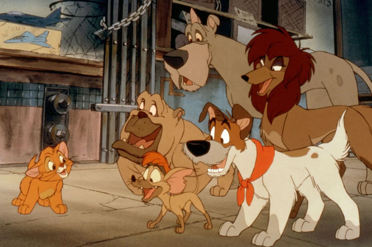 Oliver, an orange kitten, smiles at a group of dogs, including a bulldog, a chihuahua, a Great Dane, and several more in Disney’s animated movie Oliver & Company