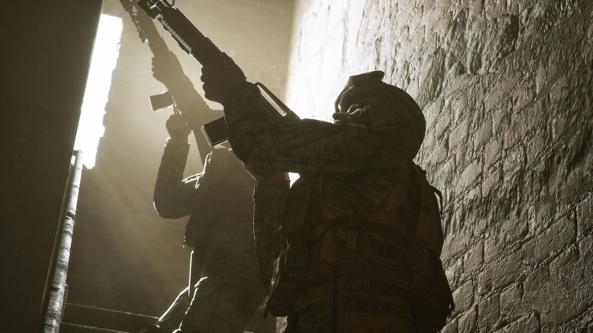 Two U.S. soldiers aim their rifles upward as they climb a staircase in a screenshot from Six Days in Fallujah