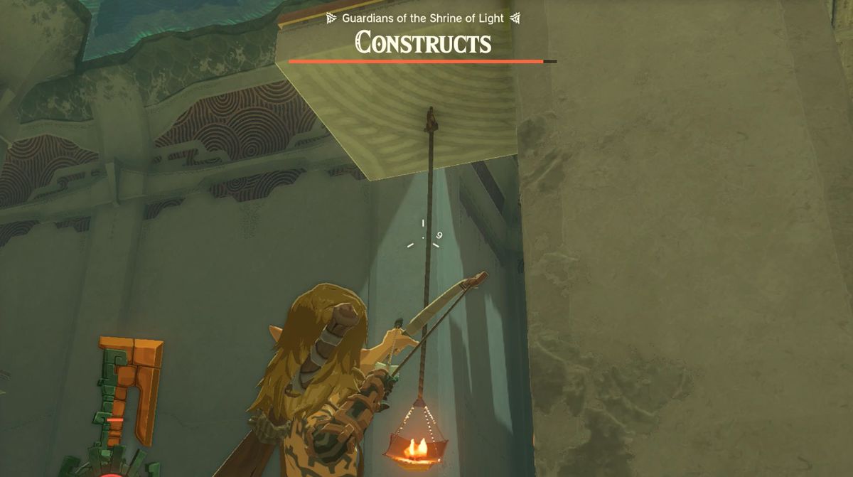 Link avfyrar en pilbåge mot en hängande ficklampa i Otak Shrine 'Proving Grounds: Traps'-uppdraget i Zelda: Tears of the Kingdom