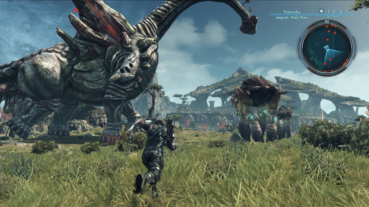 The protagonist running across a green field towards a large creature, and some stone ruins, in Xenoblade Chronicles X