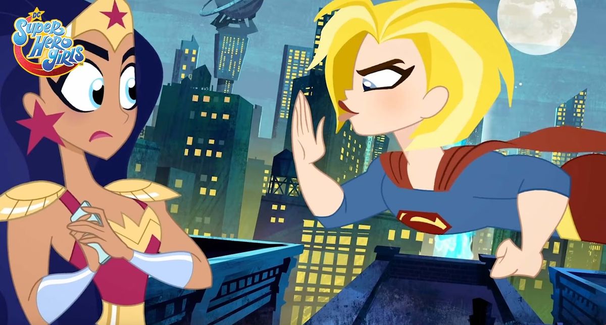 A punk-looking animated Supergirl with short, tousled hair and dramatic eyeliner makes a karate-chop gesture at a startled-looking Wonder Woman in a promo still from the kids’ animated series Super Hero Girls