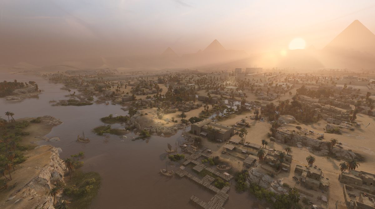 Staden Memphis, under bronsåldern Egypten, i skymningen, med palmer längs Nilen och en svindlande labyrint av stadsgator i Total War: Pharaoh