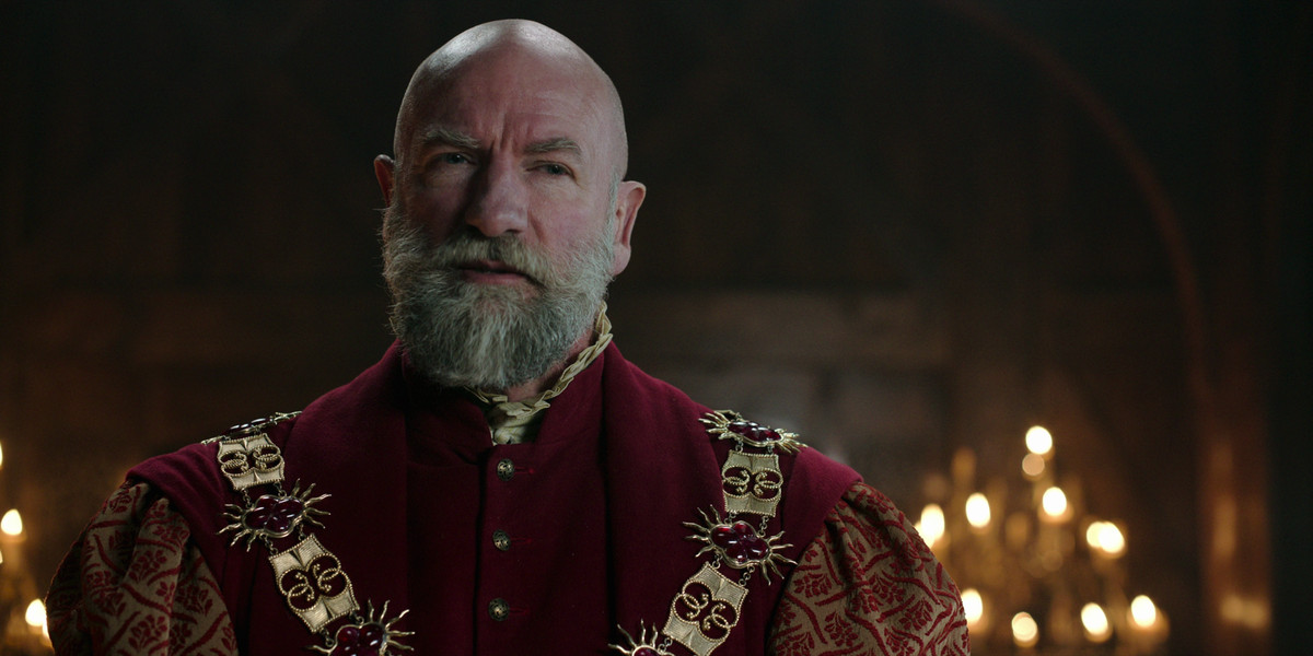 Dijkstra (Graham McTavish) tittar på något i en stillbild från The Witcher