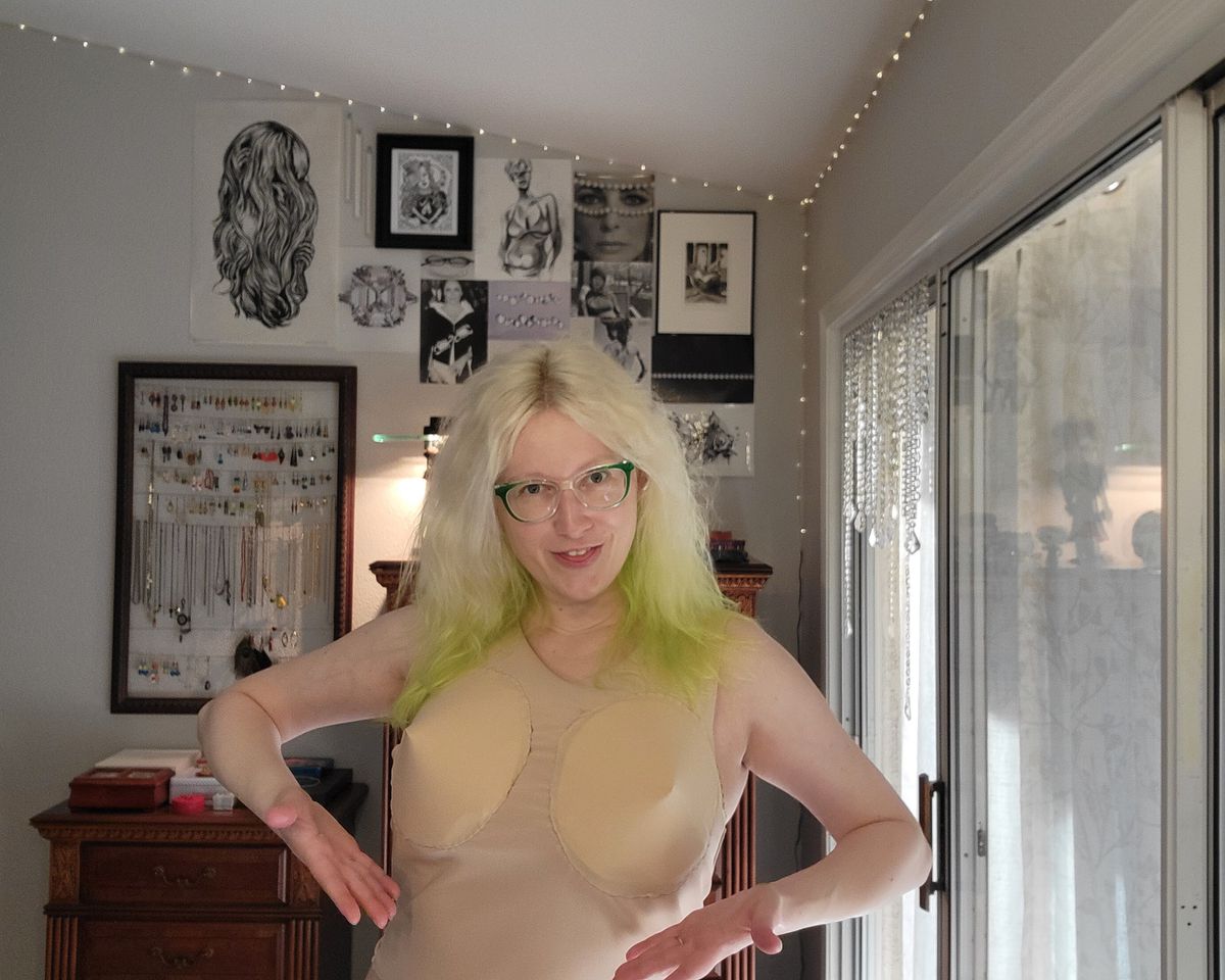 The writer wearing the light-skin colored tank top with pointing boobs.