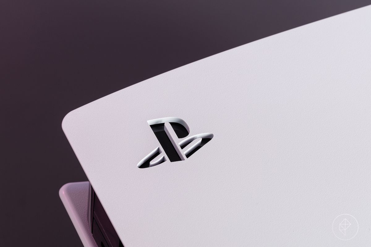 A close-up of the stenciled PlayStation logo on the white side panel of the PS5