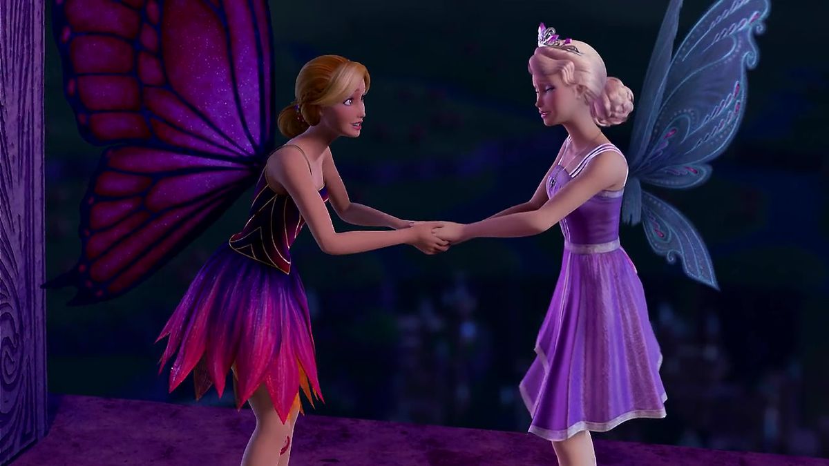 Mariposa, a fairy with butterfly wings, holds hands with Catania, a fairy with crystal wings. They are both blonde, though Mariposa’s hair is darker.