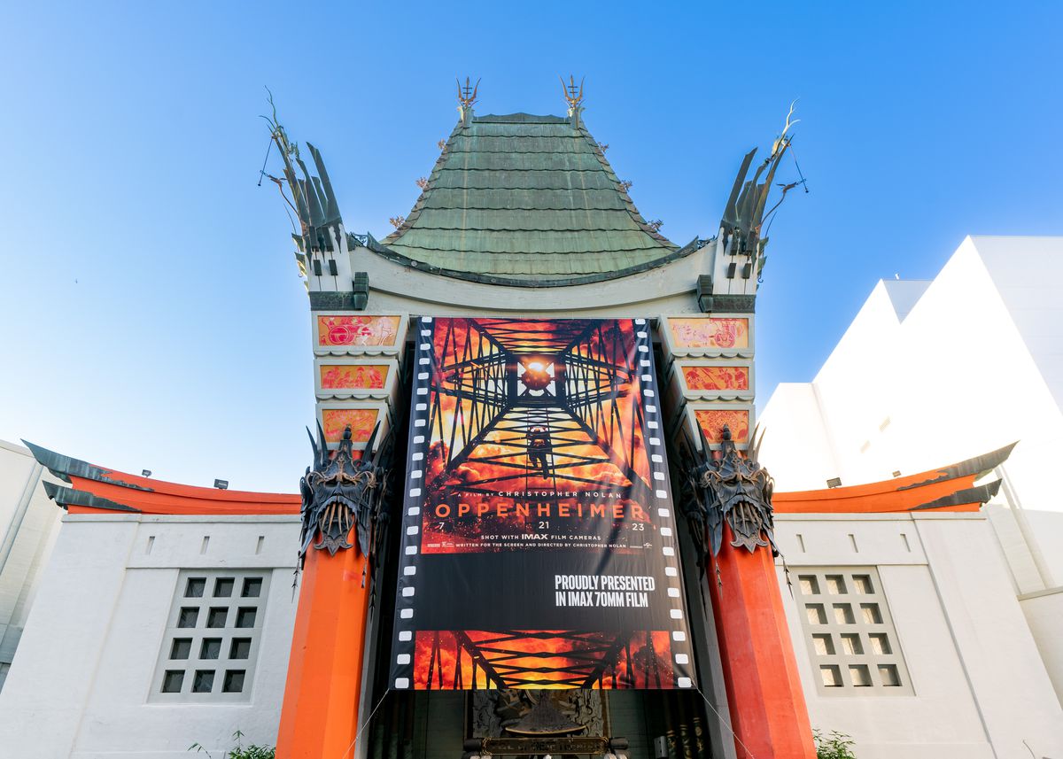 An exterior view of the TCL Chinese Theatre in Hollywood, with a banner announcing the new Christopher Nolan film Oppenheimer in IMAX 70mm