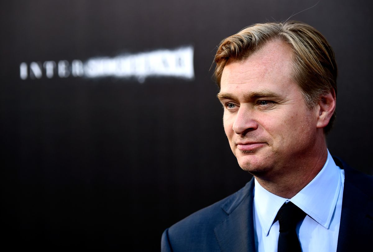 Christopher Nolan stands in front of a dark screen projecting the title of his movie Interstellar at the film’s premiere at the IMAX theater in Hollywood