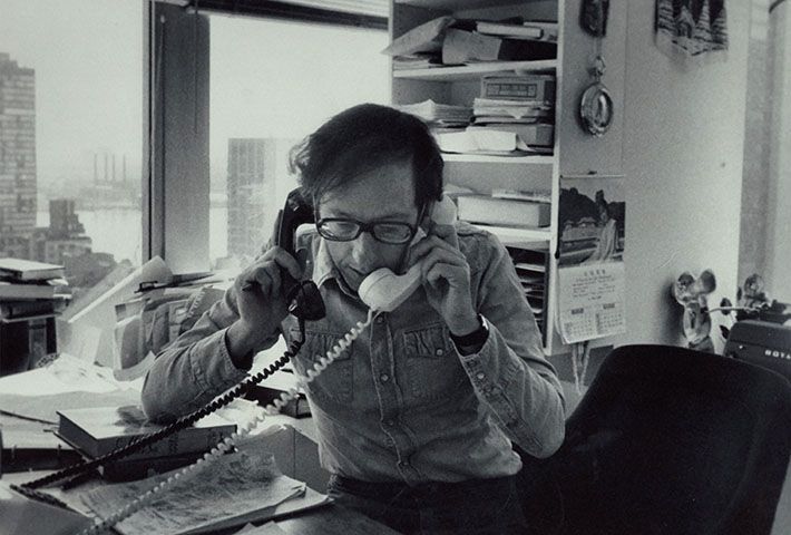 An archival photo of Robert Gottlieb speaking on two corded telephones simultaneously featured in the documentary Turn Every Page: The Adventures of Robert Caro and Robert Gottlieb