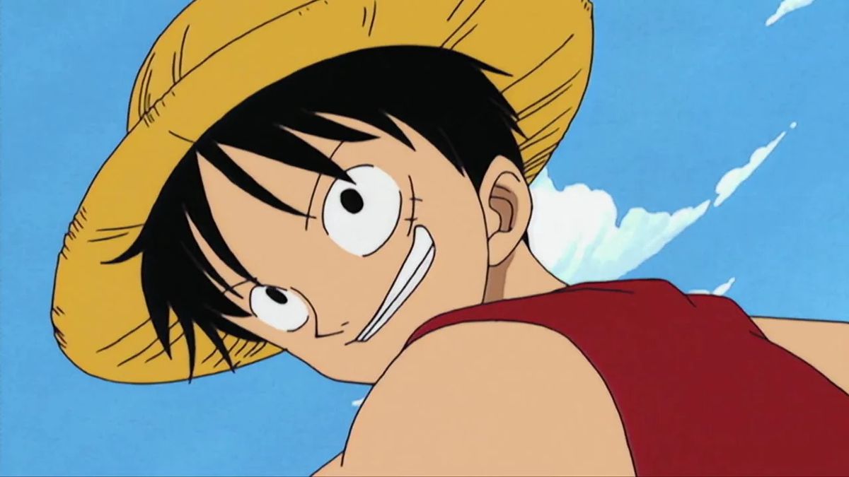 Luffy tittar tillbaka över axeln och ler i en stillbild från ett tidigt avsnitt av One Piece
