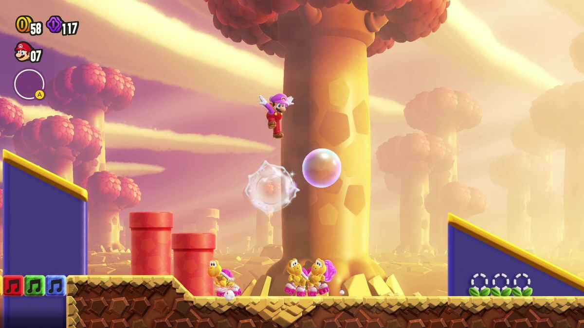Mario hoppar på en bubbla över en trio av rullskridskor Koopas i en skärmdump från Super Mario Bros. Wonder