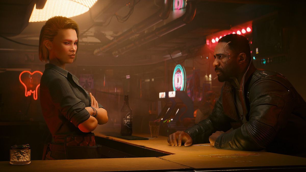 Idris Elba’s digital avatar sits at a bar across from a red-haired woman bartender in a futuristic bar from Cyberpunk 2077: Phantom Liberty