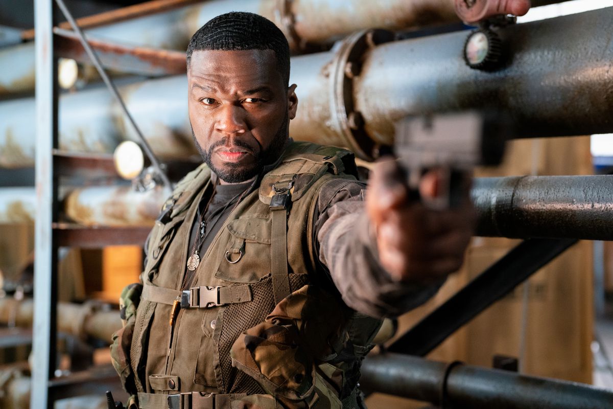 Curtis “50 Cent” Jackson aims a gun at the camera in Expend4bles
