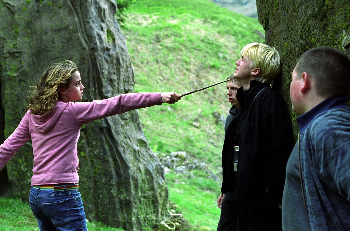 Hermione Granger holding her wand up to Draco Malfoy’s neck in Harry Potter and the Prisoner of Azkaban.