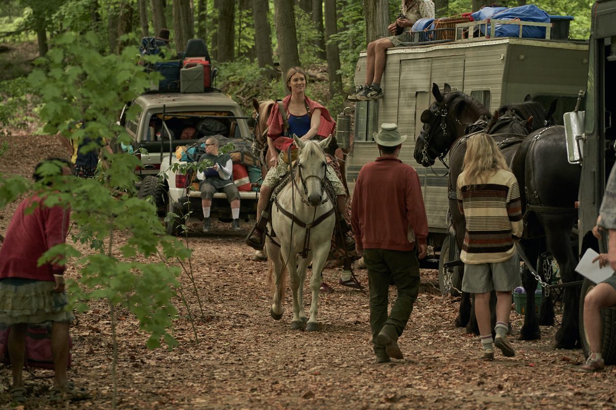 Kirsten (Mackenzie Davis) riding a horse as a member of the traveling Shakespeare troupe in Station Eleven