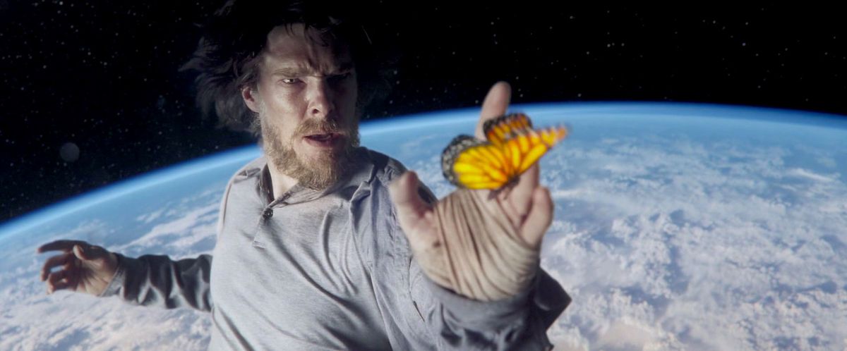 doctor strange floats above the earth touching a butterfly