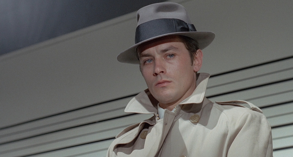 Alain Delon in his iconic Le Samourai outfit, looking gorgeous as always.