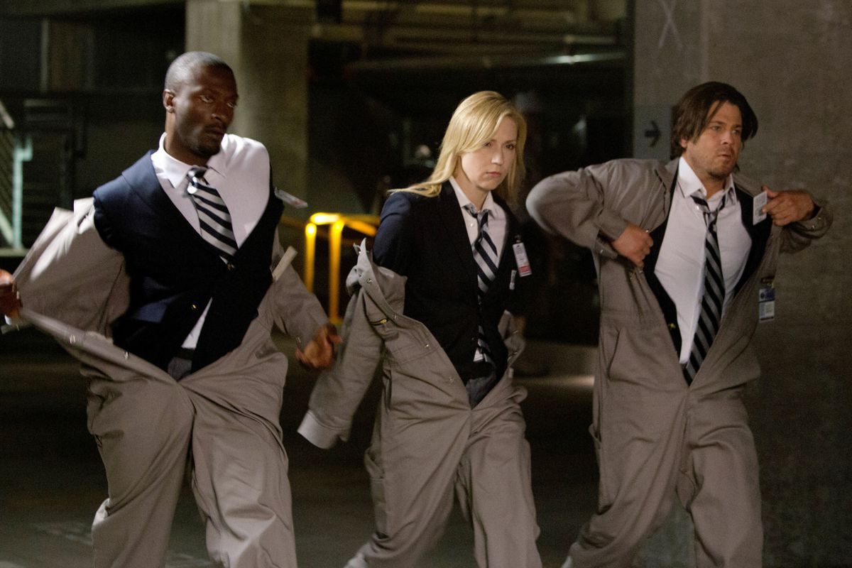 Aldis Hodge, Beth Riesgraf, and Christian Kane are in various states of changing from a working jumpsuit into suit and ties (or vice versa?) in Leverage.