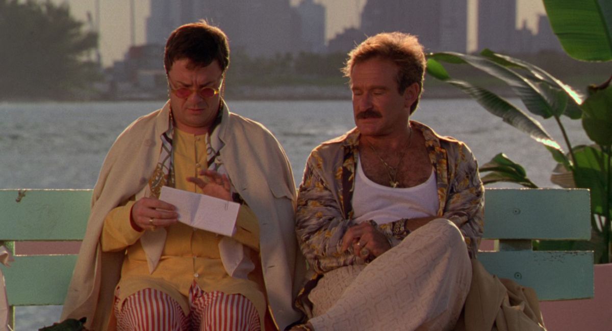 Nathan Lane and Robin Williams sitting on a bench in The Birdcage.