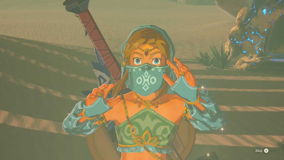 Link klädd som en Gerudo-kvinna i The Legend of Zelda: Breath of the Wild.  Han är klädd i en blå slöja, handskar och en crop top.