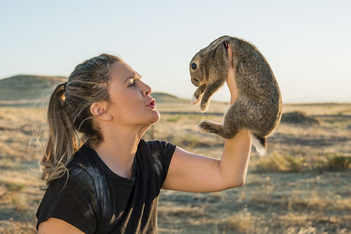 Drew Barrymore holds up a rabbit in the desert in Santa Clarita Diet