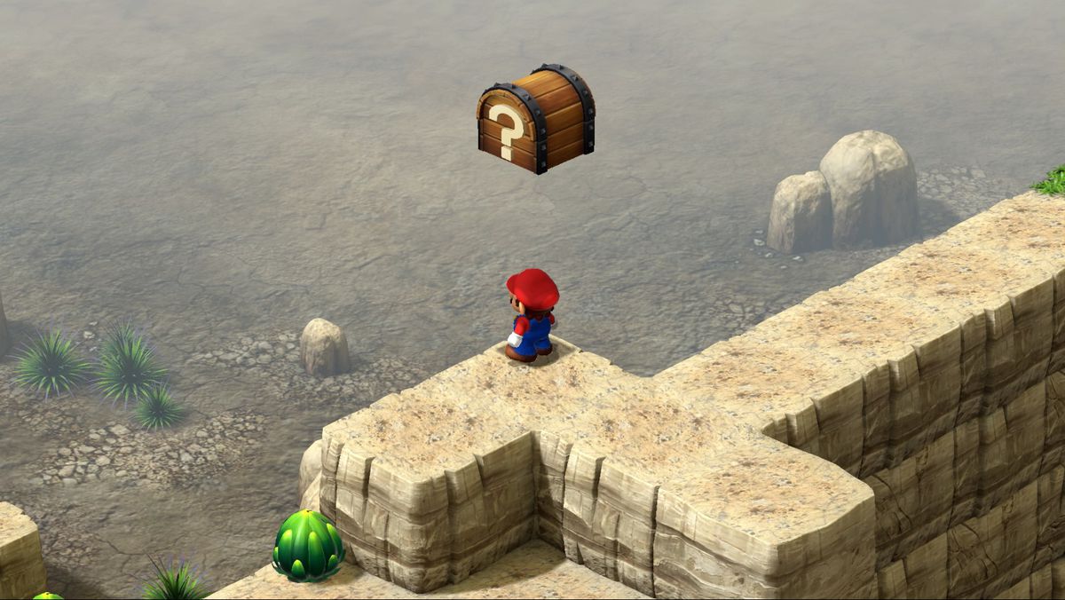 Mario stands in the corner of a desert cliff in Super Mario RPG.