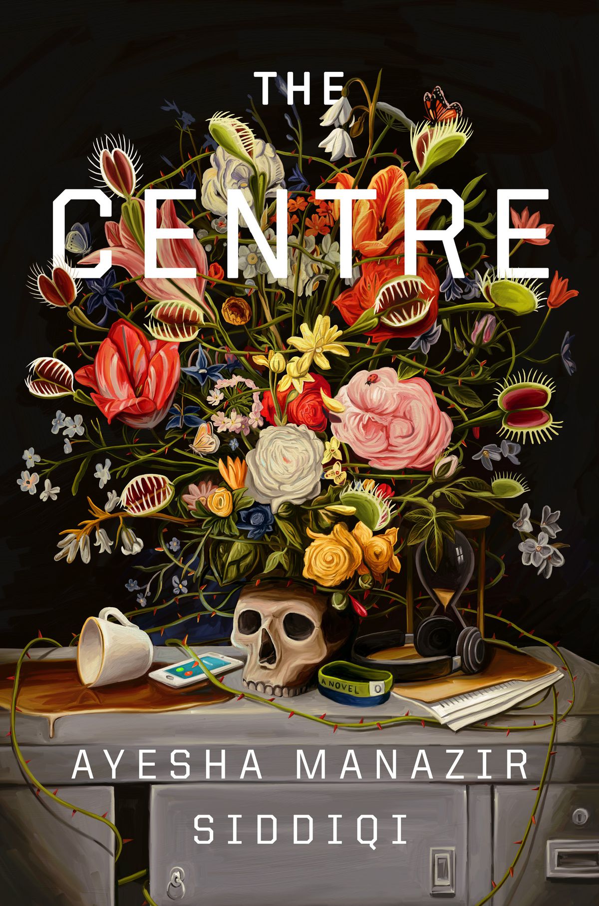 Cover image for Ayesha Manazir’s Siddiqi’s The Centre, which features a cluttered desk with a big bouquet of flowers, a skull, and an hourglass.