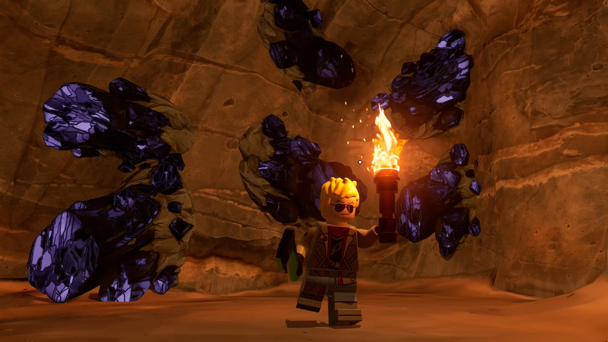 Lego Fortnite character in front of obsidian deposits in a Dry Valley cave