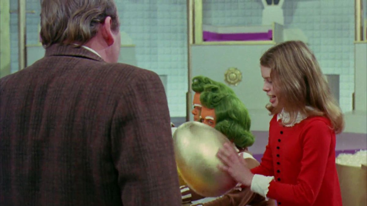 Veruca Salt holding a golden egg