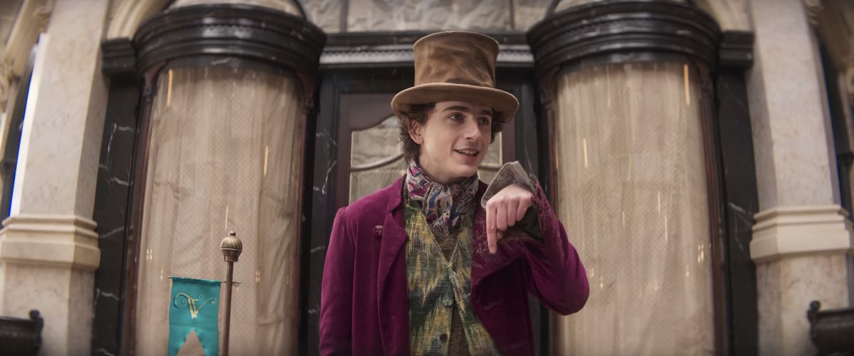 Timothee Chalamet pointing down as Wonka