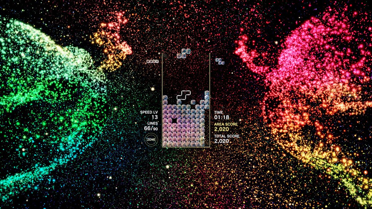 Två partikelbaserade änglavarelser dansar på sidan av en Tetris Effect-nivå.