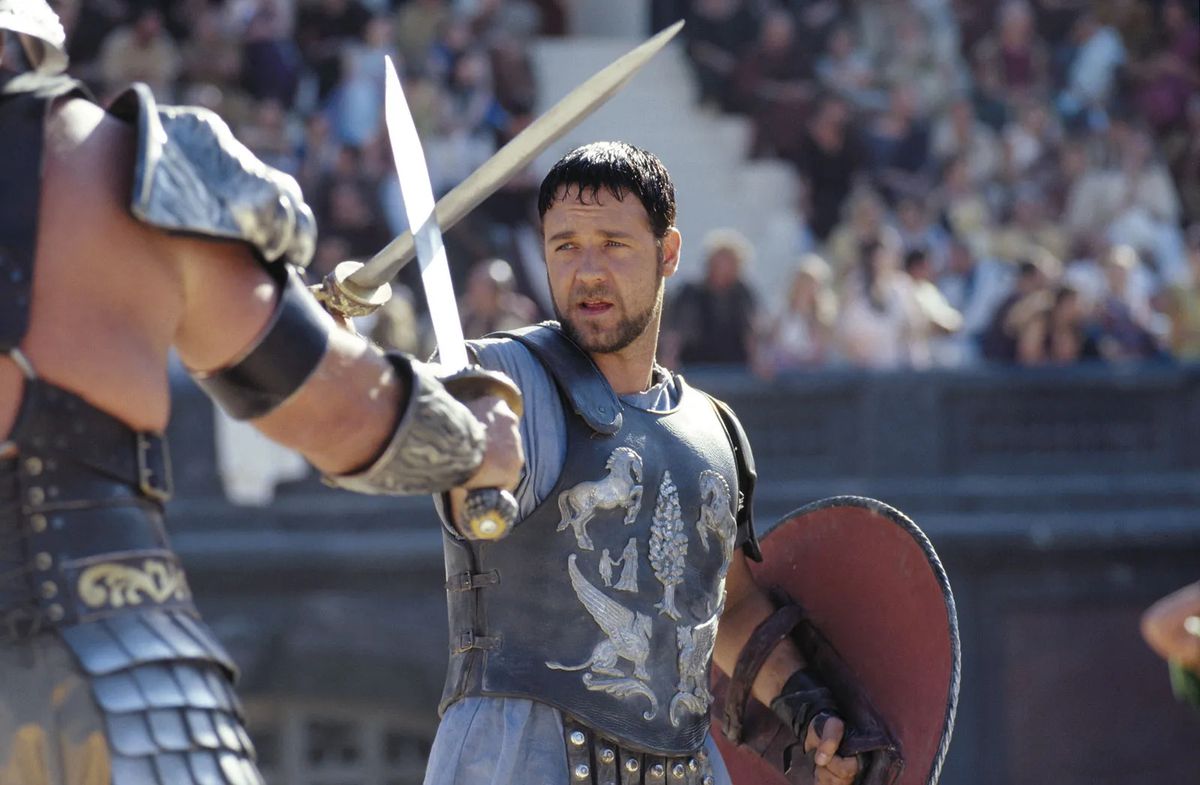 Russell Crowe som general Maximus Decimus Meridius korsar svärd med en gladiator i Gladiator.