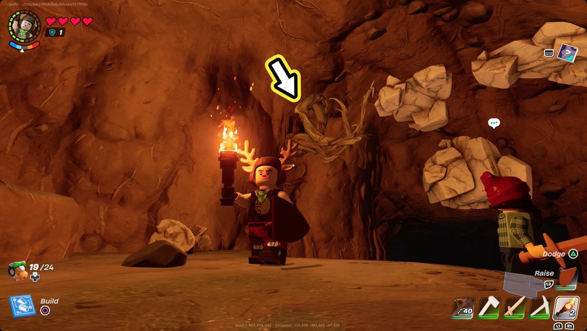 Lego Fortnite-spelare i en grotta nära lite marmor och knotroot