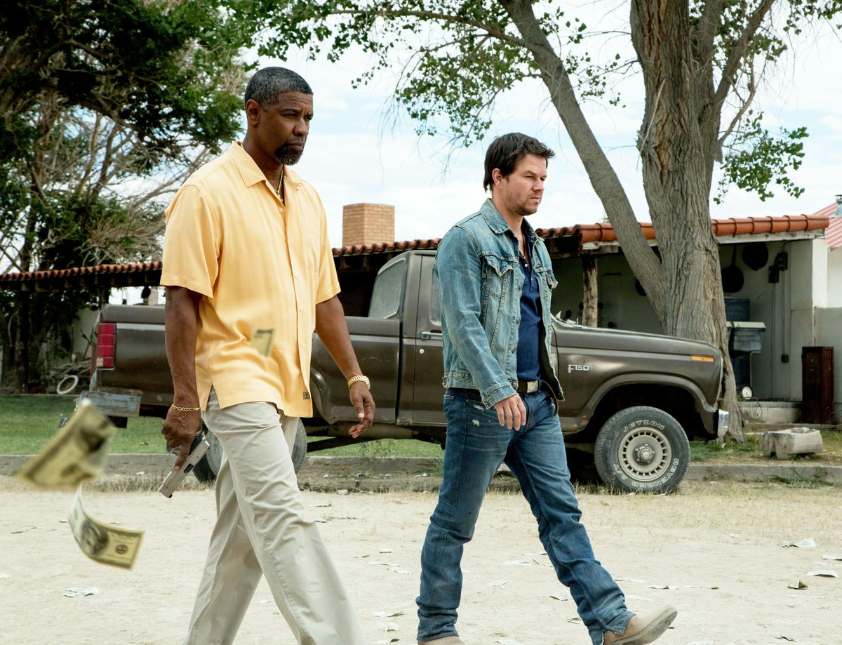 Denzel Washington and Mark Wahlberg saunter forward as money falls from the air in 2 Guns