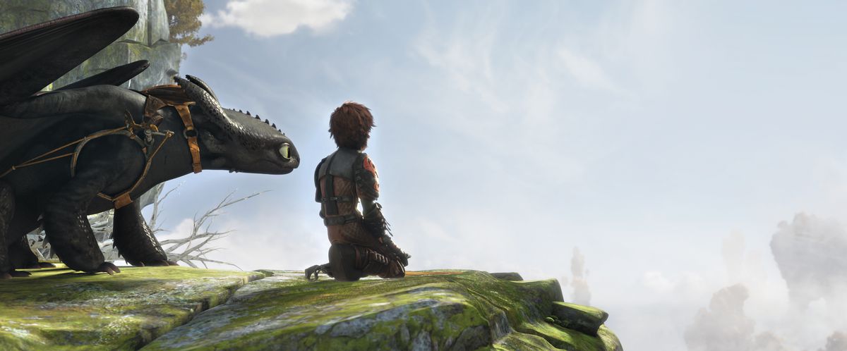 Hiccup sits on the edge of a cliff with Toothless