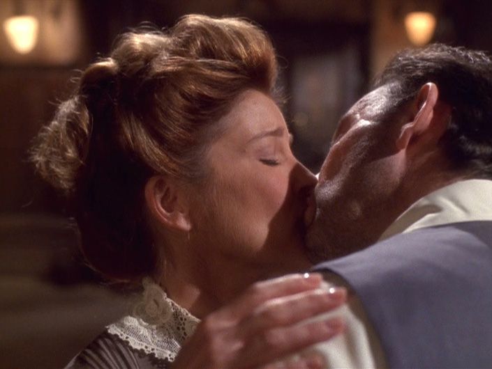 In period costume, Captain Janeway kisses a man in Star Trek: Voyager