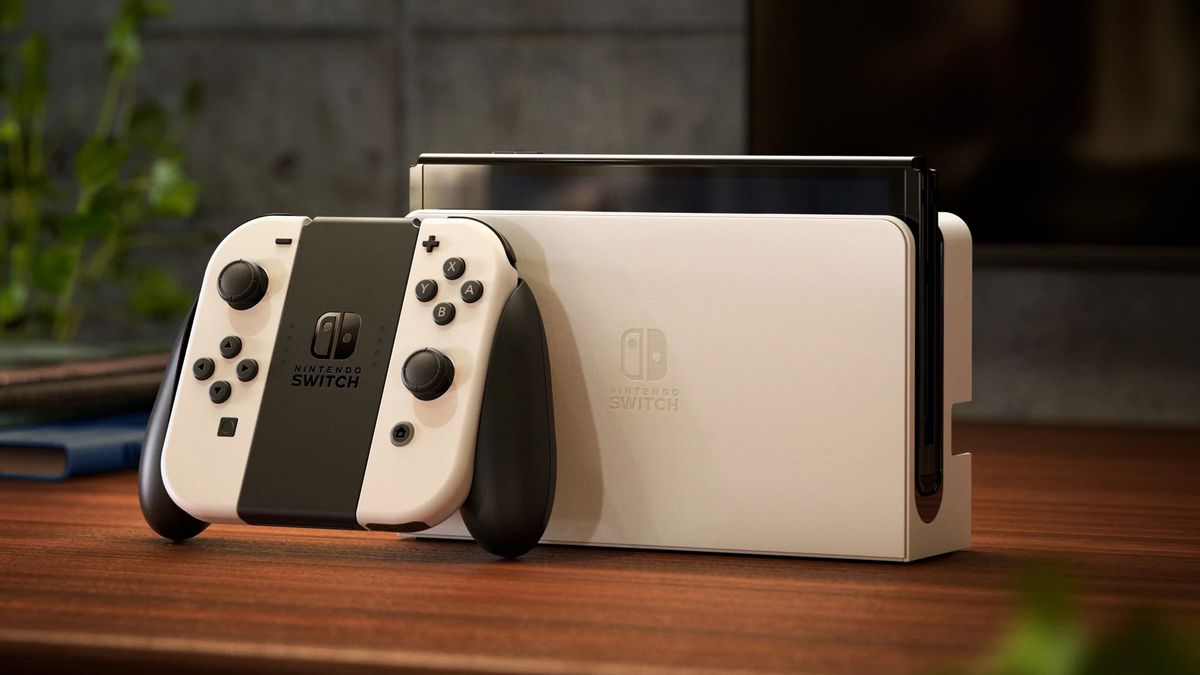 Ett foto av Nintendo Switch (OLED-modell) i vitt på ett träbord