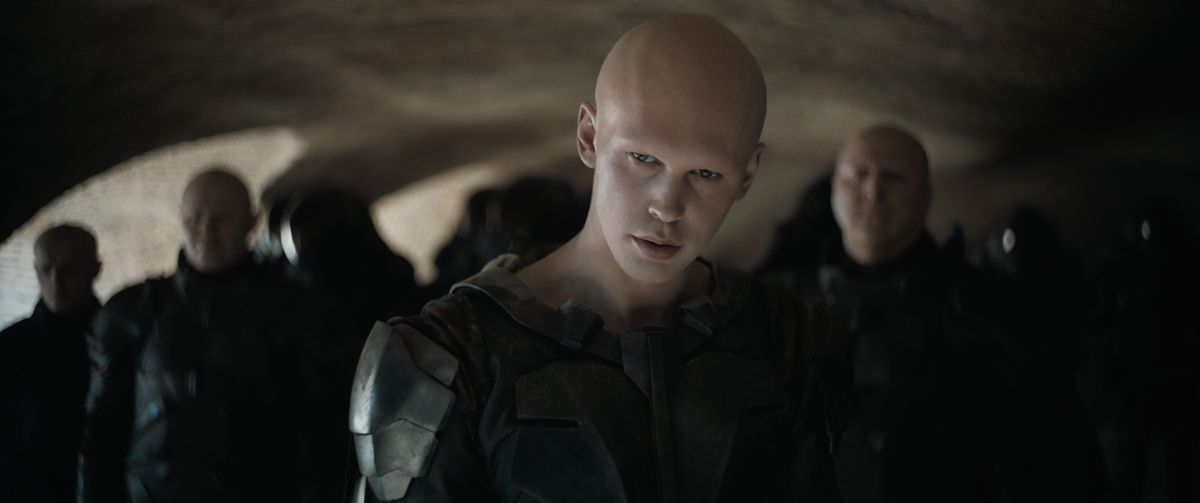 Austin Butler som Feyd-Rautha Harkonnen klädd i helsvart med en grupp soldater bakom sig i Dune: Part Two