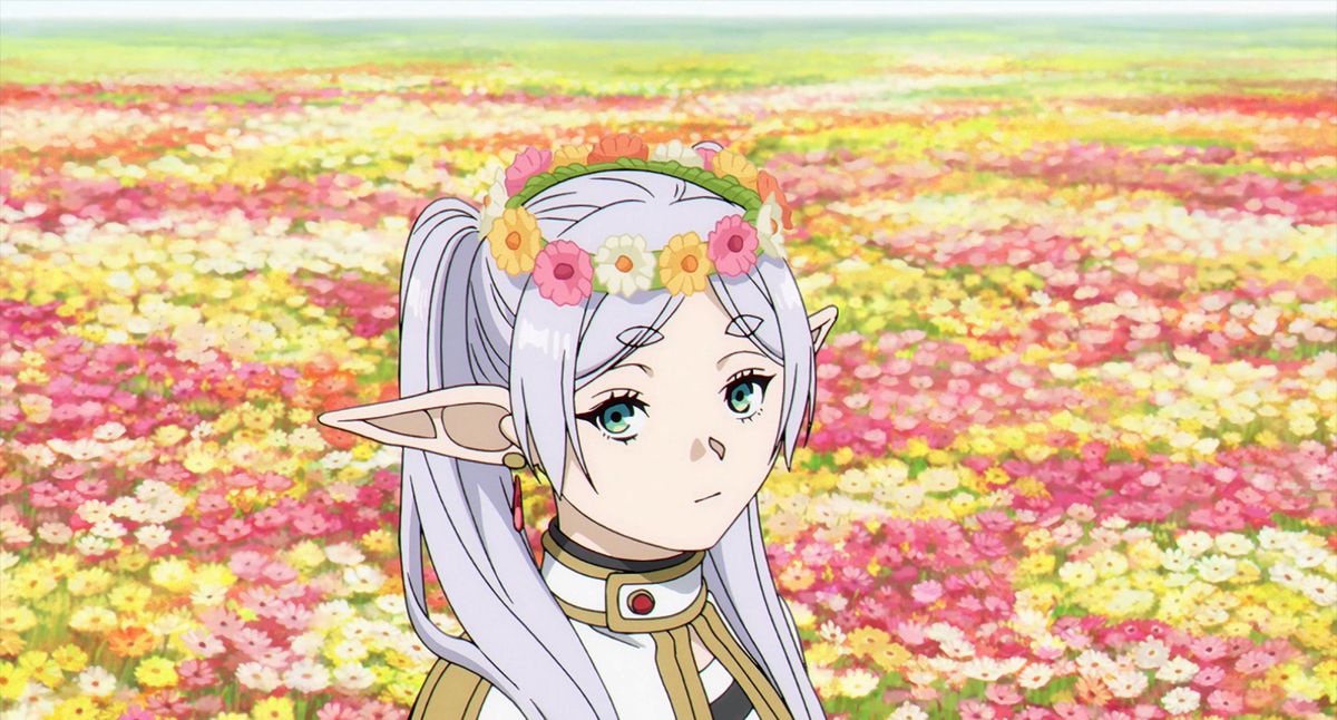 Frieren står i ett fält av blommor med en blomkrona på huvudet i Frieren: Beyond Journey's End.
