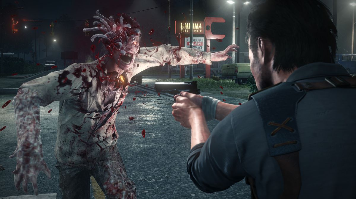 This screenshot from The Evil Within 2 shows protagonist Sebastian Castellanos facing off against a mutated human. The creature is lunging at Sebastian, covered in blood and with strange worm-like creatures coming out of its head and a single glowing red